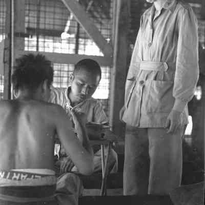 Photo of two men and a woman during WWII.