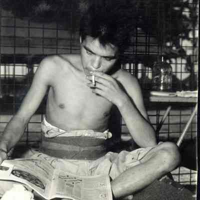 Photo of man reading newspaper during WWII.