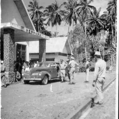 Photo of man getting out of car during WWII.