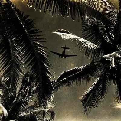 WWII airplane in flight. There is damage to the left side of the picture.
