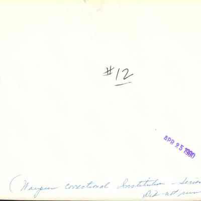 Back of photo of inmates making license plates