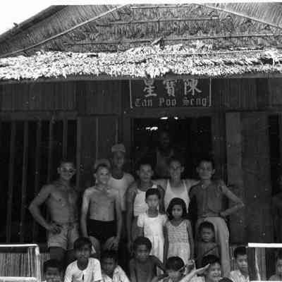 Military personel and natives. Label above door says Can Poo Scng
