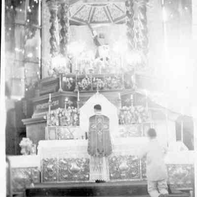 Priest at altar.