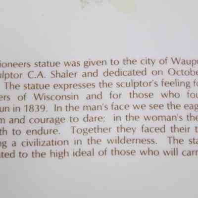 Back of plate description "The Pioneers" sculpture
