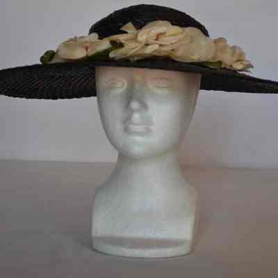 Wide brim straw hat with low crown and white flowers around band