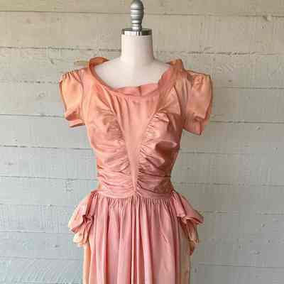 Taffeta cap sleeve evening gown with ruching panels on front and gathered side and back peplum