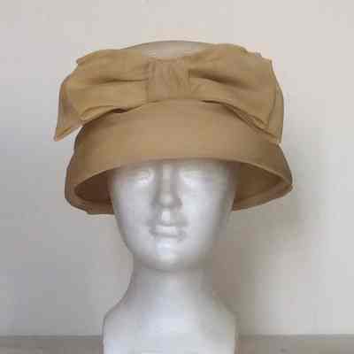 Straw flower pot hat with silk covered brim and silk bow on front crown