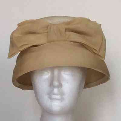 Straw flower pot hat with silk covered brim and silk bow on front crown