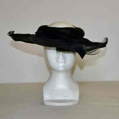 Open crown hat with wide tulle brim and black velvet ribbon band