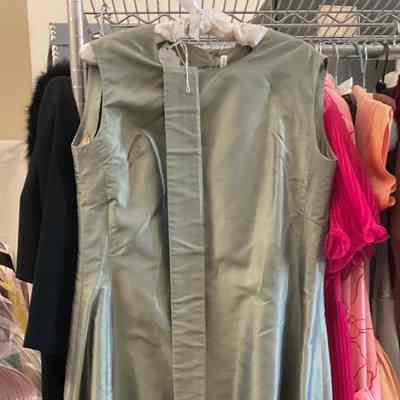 Sleeveless floor length princess seamed gown with self belt with bow.