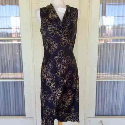 Sleeveless cowl neck sheath dress in black and gold print