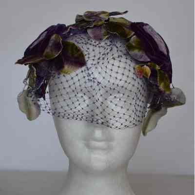Small casque with velvet flower/leaves with purple net veil