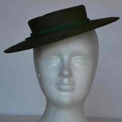 Small straw tilt hat with green hat band