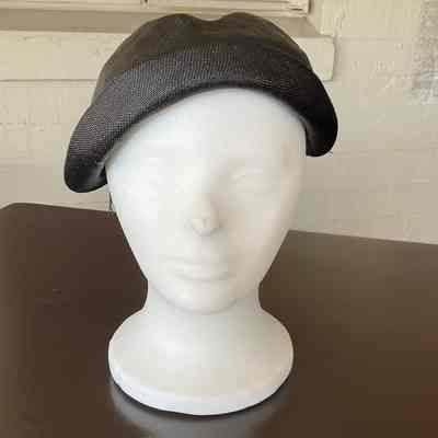 Black straw close fitting half hat with small brim and black velvet trim
