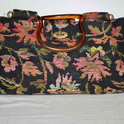 Unstructured tapestry bag with brown lucite handles, double handle, u shape gold tone knobs, black vinyl bottom