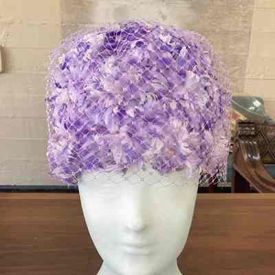 Mesh pillbox covered with purple flowers and a layer of Russian veiling