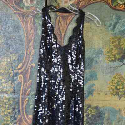 Black sequined halter dress with scalloped hem and neck