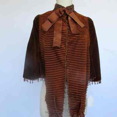 Hook front velvet and corduroy cape with bead embellishment and bows
