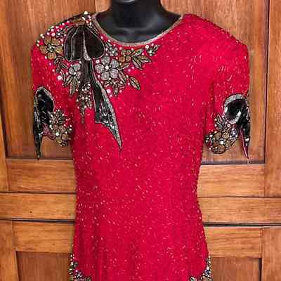 Short padded sleeve beaded dress with ruffles at hem and contrast bead embellishments