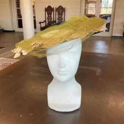 Felt crown and straw brim hat with white roses on brim covered with tulle