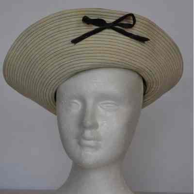 Wool hat with decoratively stitched turned up brim with bow and wide leather band on crown