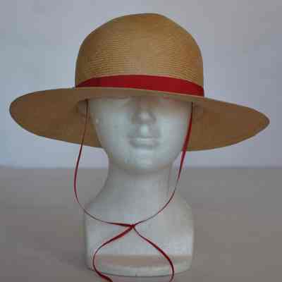 Straw sun hat with rounded crown, red grosgrain band and ties