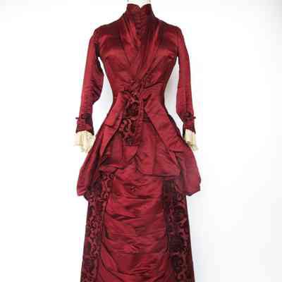 Long sleeve satin bodice with covered buttons and lace trim cuffs, full length double layer satin skirt with burnout velvet panels