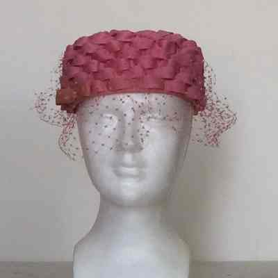 Mesh pillbox covered with pink ribbon in basketweave design with Russian veiling and pink bow
