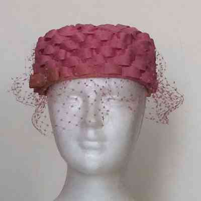 Mesh pillbox covered with pink ribbon in basketweave design with Russian veiling and pink bow
