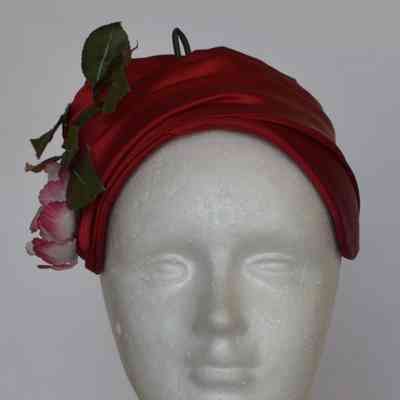 Pleated fabric calot with faux flowers