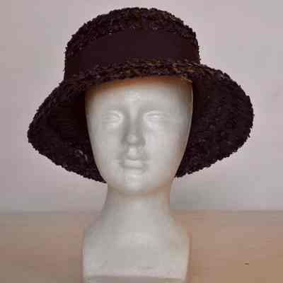 Straw boater with downward curved rim and wide grosgrain hatband with bow on the back