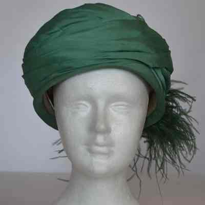 Pleated and draped silk toque with plumes