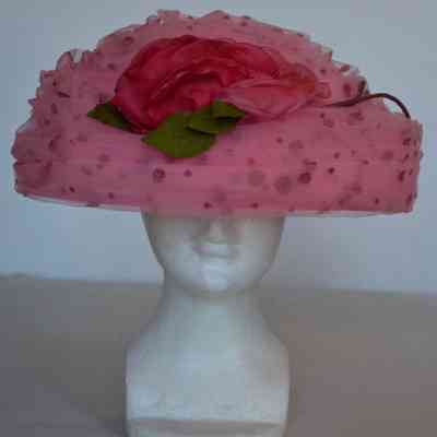 Pleated and draped dotted tulle covered hat with flower embellishment at center front