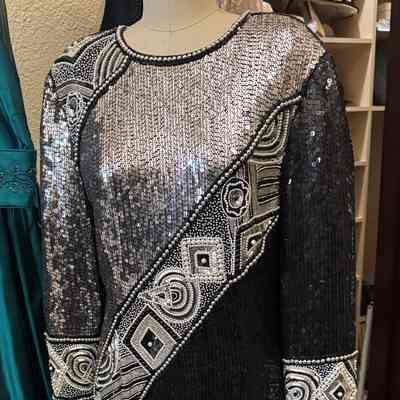 Long sleeve, asymmetrical design motif embellished with white pearls and beads and black and silver sequins