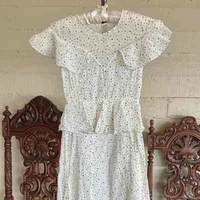 Sleeveless dotted cotton dress with peplum and ruffled yoke