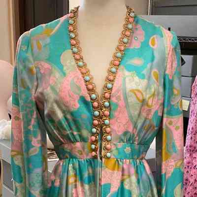 Long sleeve printed dress with set in waist and beaded gold trim at neck