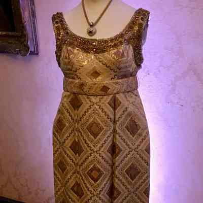 Brocade sleeveless full length dress with empire waist, self belt and beaded embellishment around neck and armholes