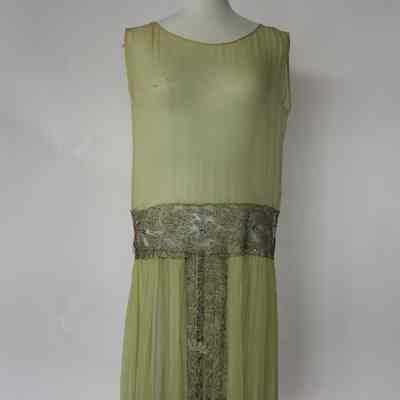 Sleeveless chiffon drop waist dress with embellished gold lace insets at waist, hem and center skirt