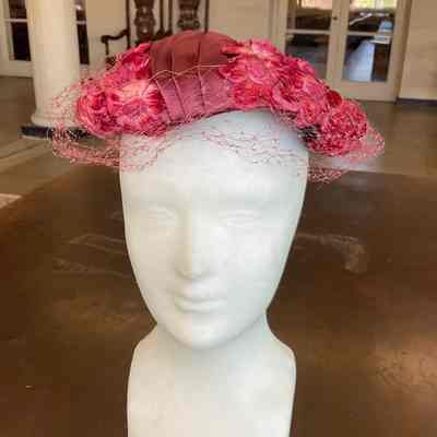 Flower covered casque with pleated satin detail and veil