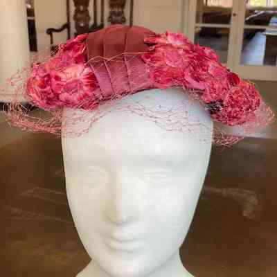 Flower covered casque with pleated satin detail and veil