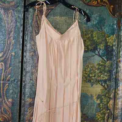 Sleeveless pleated shift with string-tied straps and tie at low waist