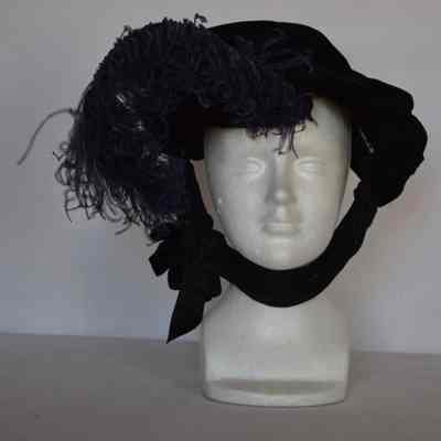 Velvet slouch bonnet-style hat with purple plume and jersey tie