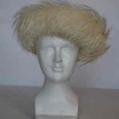 Hat with crown and turned up brim both covered in feathers