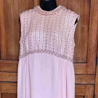 Sleeveless evening gown with heavily beaded empire bodice