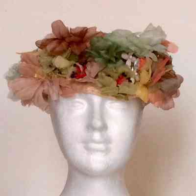 Crochet pillbox covered with multicolor flowers around the sides