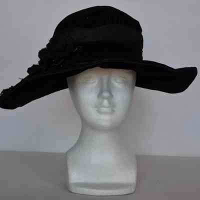 High crown with large floppy brim, wide hat band, crown embellishment