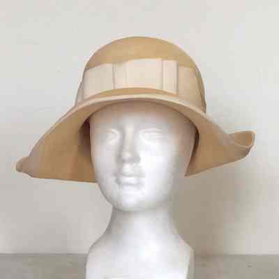 Straw sun hat with beige gros grain bow on crown and trim on brim edge