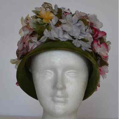 Faux flower covered velvet toque with narrow brim