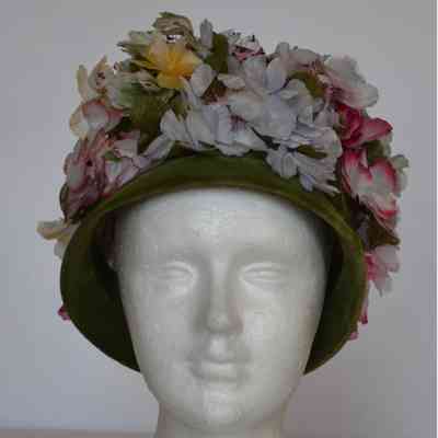 Faux flower covered velvet toque with narrow brim