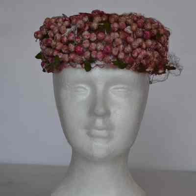Berry/faux flower covered pillbox with netting veil